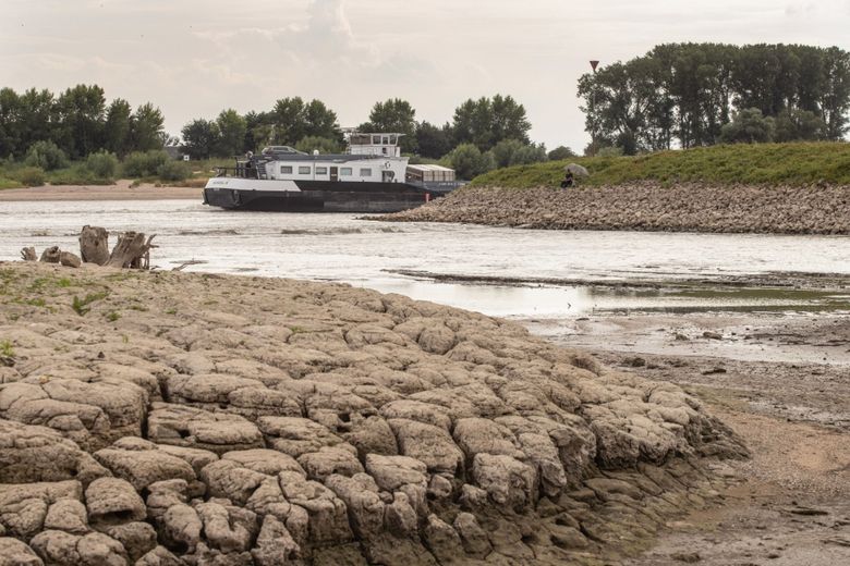 An exposed riverbed due to low waters caused by drought on the Rhine River in Lobith, Netherlands, on July 30. (Peter Boer / Bloomberg).