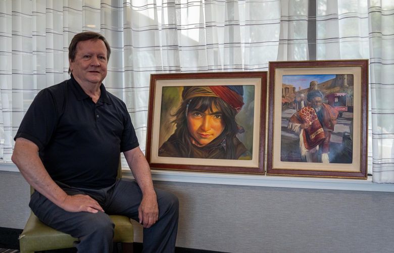 Timothy Ham displays some of the artwork created by Abdul, an artist in Afghanistan. He has played been a significant role in working to help Abdul leave Afghanistan with his family and come to Tacoma.