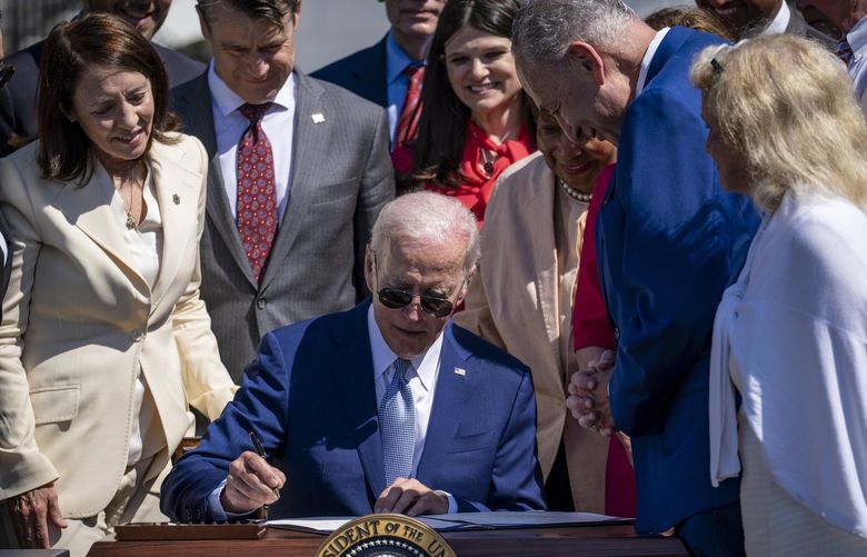 President Joe Biden signs into law H.R. 4346, known as the CHIPS and Science Act of 2022, in a ceremony held on the South Lawn of the White House in Washington on Tuesday, Aug. 9, 2022. The landmark bill will provide $52.7 billion in subsidies for U.S. semiconductor production and research and boost efforts to make the United States more competitive with China’s science and technology efforts. (Pete Marovich/The New York Times)