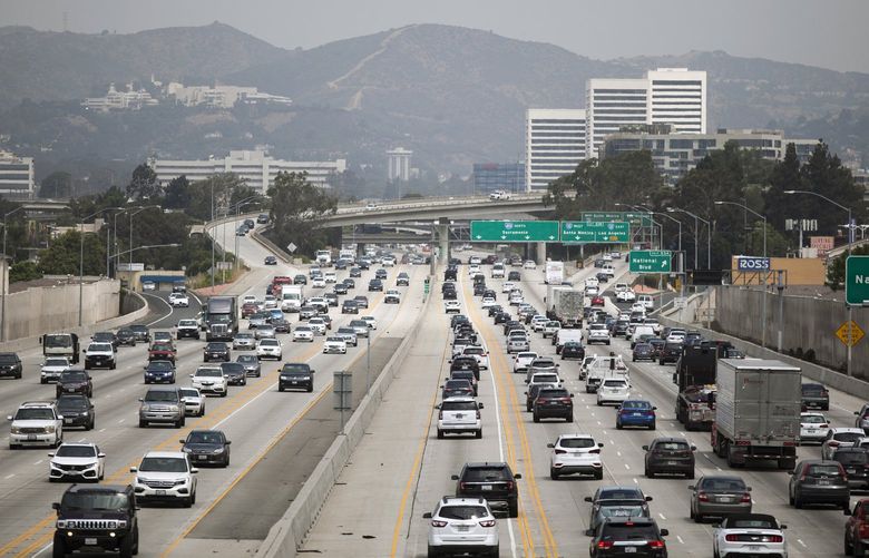 FILE — Traffic on the I-405 Highway in Los Angeles on July, 25, 2019. At least 12 other states are already in line to adopt California’s zero-emissions vehicle mandate. (Jenna Schoenefeld/The New York Times)