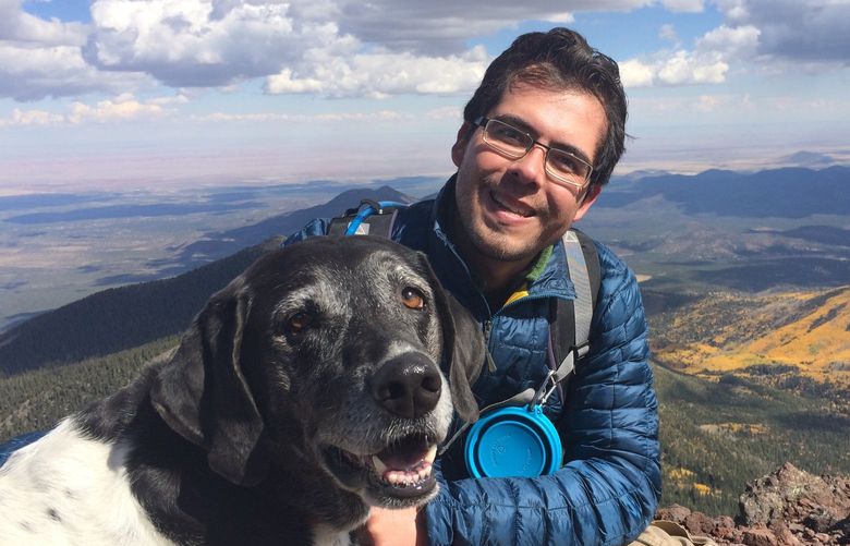 Luis Carrasco and his dog, Penelope, at the top of Humphreys Peak, the highest point in Arizona, on Oct. 11, 2014.