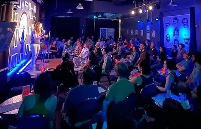 Local comedian Monica Nevi performs to a packed house at Club Comedy Seattle this July. Club owner Rick Taylor says since audiences have returned to the club after the pandemic shut them down, there are more new faces and more people seem interested in the “escape” aspect of comedy.