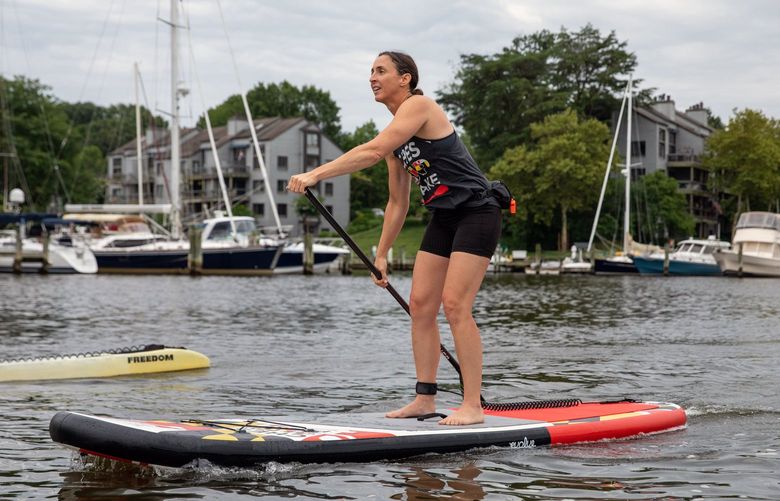 Nicole Stimpson demonstrates some of the proper techniques for stand-up paddling in Annapolis, Md., on July 26, 2022. The activity requires a variety of skills and offers a full-body workout on the water. (Amanda Andrade-Rhoades/The New York Times)