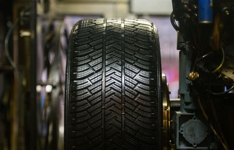 An automobile tire exits the mold on the production line at the Michelin Gravanche manufacturing plant in Clermont Ferrand, France, on Wednesday, Feb. 16, 2022. MUST CREDIT: Bloomberg photo by Nathan Laine