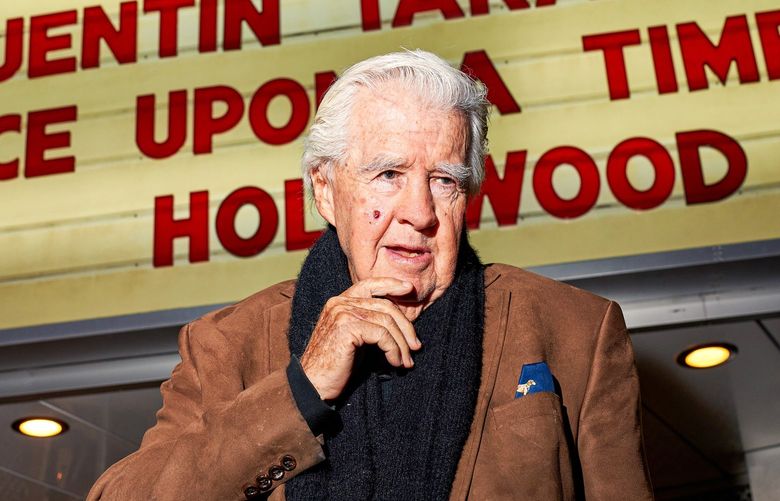 Clu Gulager, an actor who appears in “Once Upon a Time in Hollywood” stands in front of The New Beverly Cinema in Los Angeles on Jan. 4, 2020. The theater, owned by Quentin Tarantino, is riding a boom in art house theaters. (Michelle Groskopf/The New York Times)