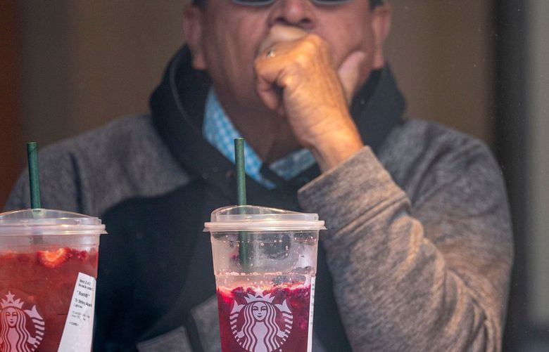 A customer has a drink inside a Starbucks coffee shop in San Francisco, California, U.S., on Thursday, July 22, 2021. Starbucks Corp. is expected to release earnings figures on July 27. Photographer: David Paul Morris/Bloomberg