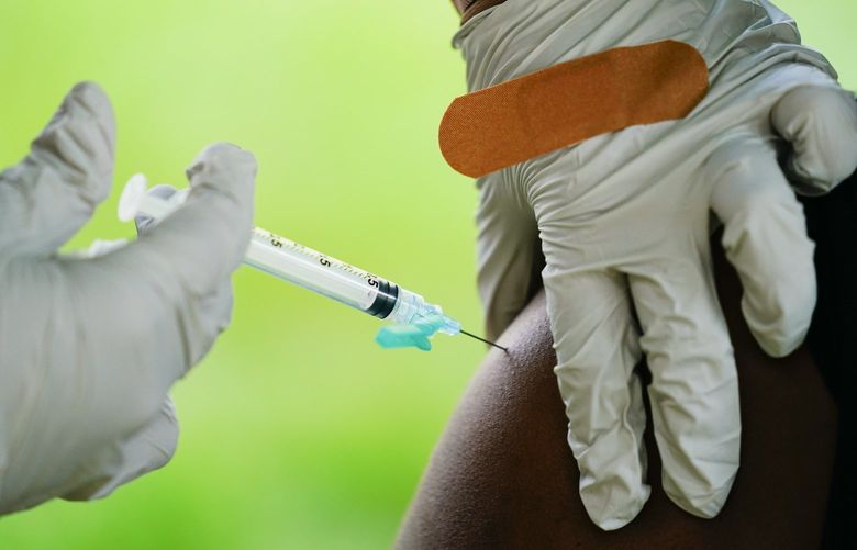 FILE – A health worker administers a dose of a Pfizer COVID-19 vaccine during a vaccination clinic in Reading, Pa., Sept. 14, 2021. Pfizer asked U.S. regulators Monday, Aug. 22, 2022, to authorize its combination COVID-19 vaccine that adds protection against the newest omicron mutants â€” a key step toward opening a fall booster campaign. (AP Photo/Matt Rourke, File)