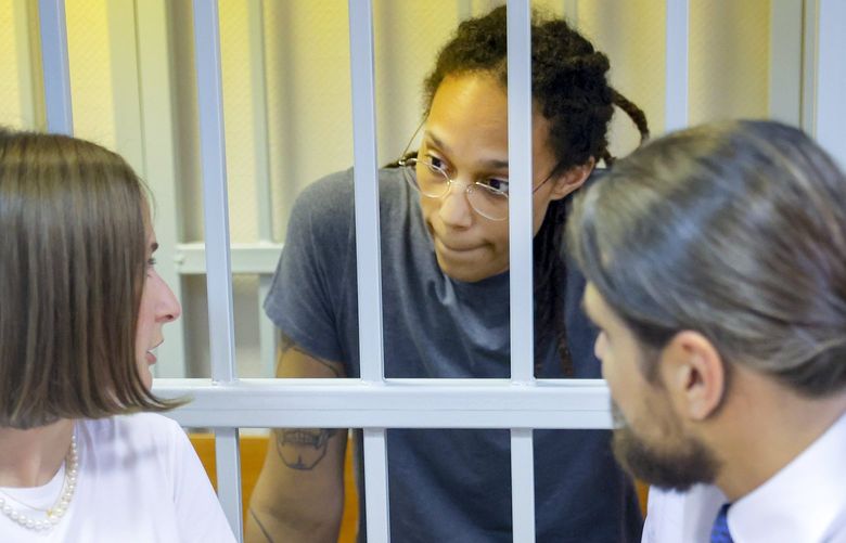 WNBA star and two-time Olympic gold medalist Brittney Griner, center, speaks to her lawyers in a courtroom prior to a hearing in Khimki just outside Moscow, Russia, Thursday, Aug. 4, 2022. Closing arguments in Brittney Griner’s cannabis possession case are set for Thursday, nearly six months after the American basketball star was arrested at a Moscow airport in a case that reached the highest levels of US-Russia diplomacy. (Evgenia Novozhenina/Pool Photo via AP) XAZ119