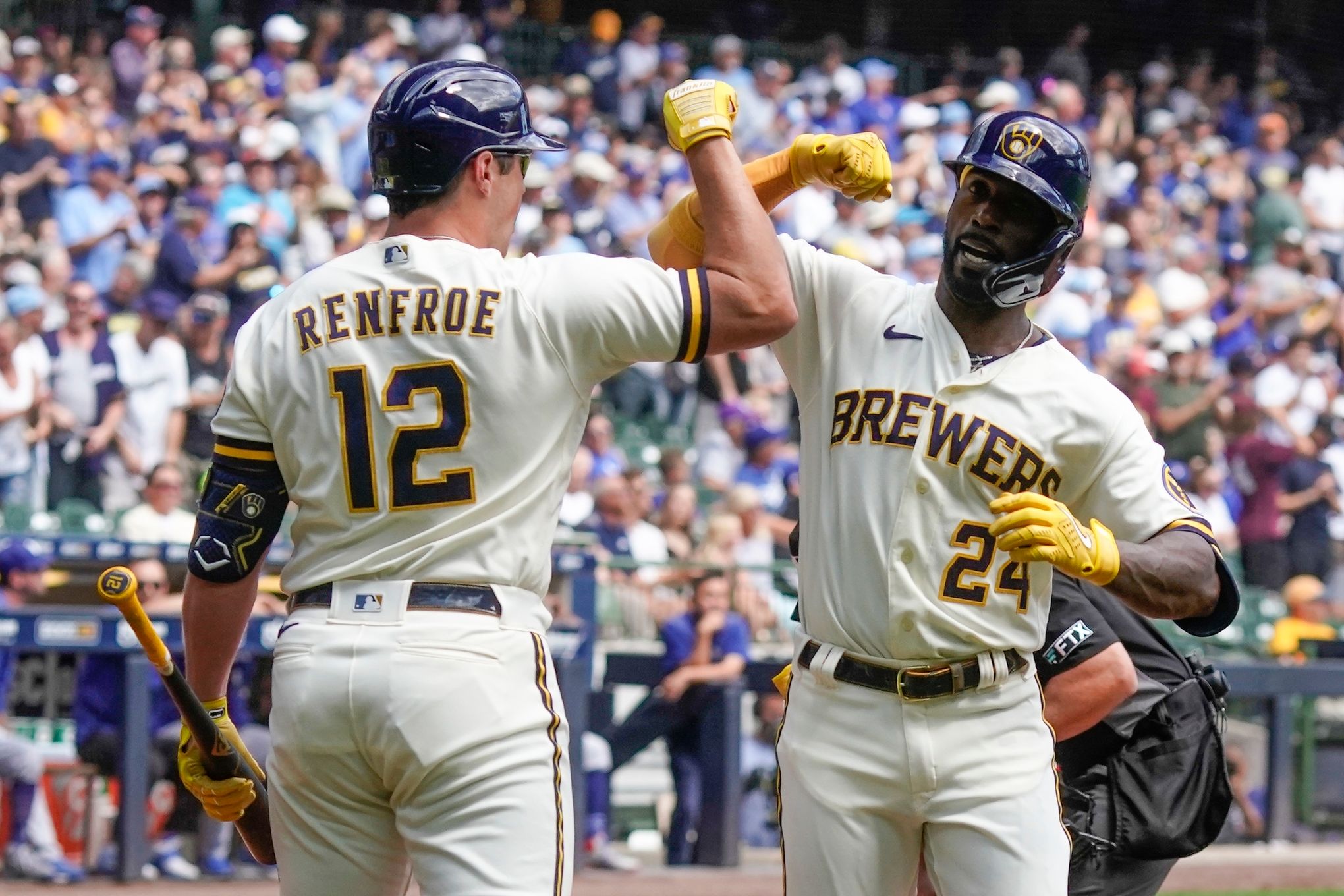 Milwaukee Brewers' Tyrone Taylor is congratulated by Hunter