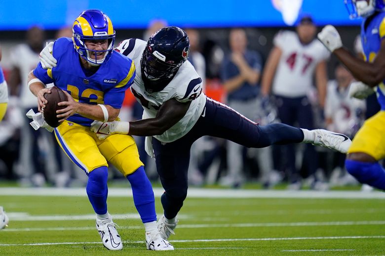 Los Angeles Rams head coach Sean McVay talks to quarterback John Wolford (13)  before an NFL