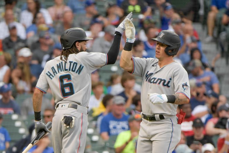 Miami Marlins' Jesus Sanchez, left, is congratulated by first base