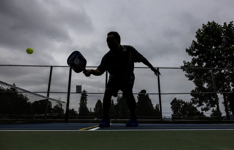 Lawrence Lee, 58, practices with his buddy Dennis Rock (not pictured) at Lakeridge Playfield on July 2, 2022. Pickleball is the official sport of the state of Washington. The game was invented on Bainbridge Island in 1965.