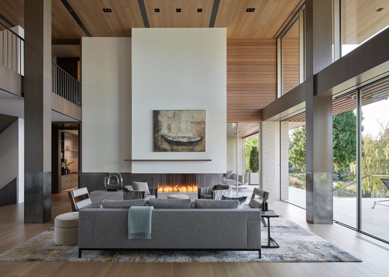 In the dramatic two-story living room of a contemporary home in Laurelhurst, &#8220;The elements of the fireplace are the same as in a traditional setting: mantel, firebox, hearth,&#8221; says Amanda Cavassa of Stuart Silk Architects. &#8220;But they are proportioned and clad in a way that melds with the contemporary aesthetic of the home.&#8221; (Kevin Scott / Courtesy Stuart Silk Architects)