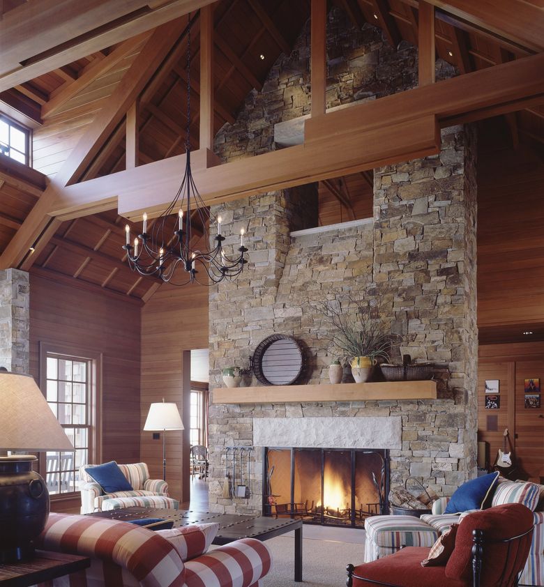 This Whidbey Island waterfront home designed by Stuart Silk Architects has two massive stone fireplaces anchoring the ends of the two-story great room under a 25-foot ceiling. (Benjamin Benschneider / Courtesy Stuart Silk Architects)