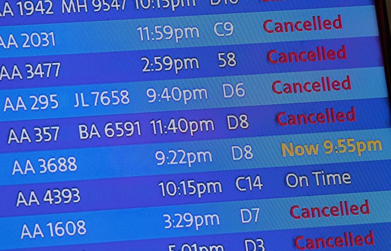 FILE – The arrivals board at the American Airlines terminal at LaGuardia Airport displays the flights that have been canceled or delayed and one that is on time, March 21, 2020, in New York. Flight delays and cancellations have bedeviled airline travel so far this year. The Transportation Department is launching a customer service dashboard to assist vacationers ahead of the travel-heavy Labor Day weekend. (AP Photo/Mary Altaffer, File) WX203 WX203