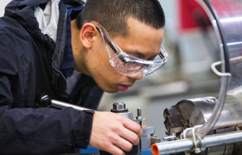 Students in the I-BEST (Integrated Basic Education and Skills Training program) at Shoreline Community College, including student Terran Vo, uses a lathe to work on his project in the machine shop run by instructor Keith Smith. A lathe is a machine for shaping wood, metal, or other material