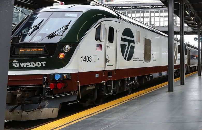 Trains on Amtrak’s Cascades, left, and Empire Builder, right, lines are seen at King Street Station, Tuesday, May 25, 2021 in Seattle.