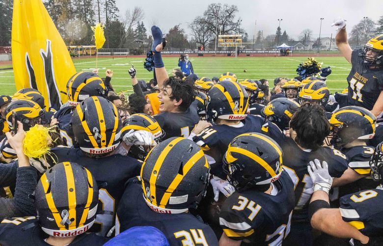 Bellevue High School celebrates their win against Kennewick High School during the WIAA mens football championship at Sparks Stadium in Puyallup on Saturday, Dec. 4, 2021.  218928