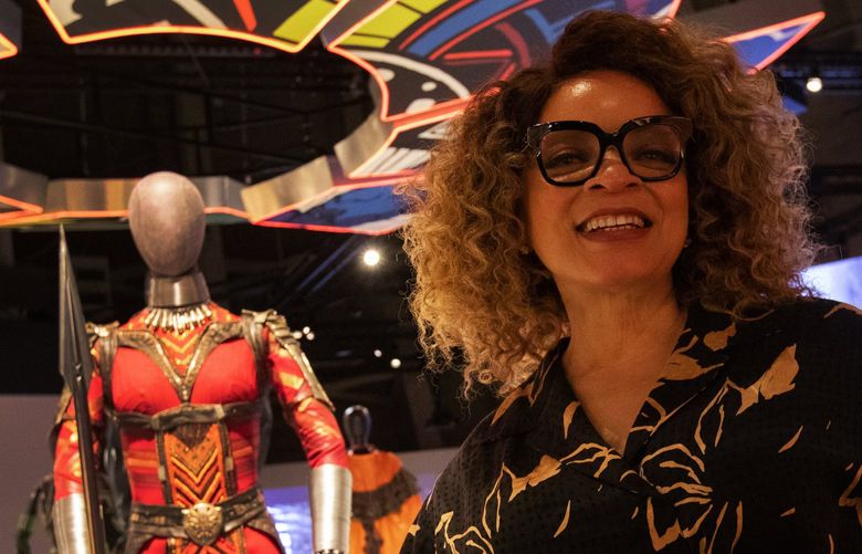 Oscar-winning costume designer Ruth E. Carter at MoPOP’s exhibit “Ruth E. Carter: Afrofuturism in Costume Design,” Thursday, June 16, 2022 in Seattle. In the background is Carter’s design used by actor Florence Kasumba for the “Black Panther” character Ayo Dora Milaje.
