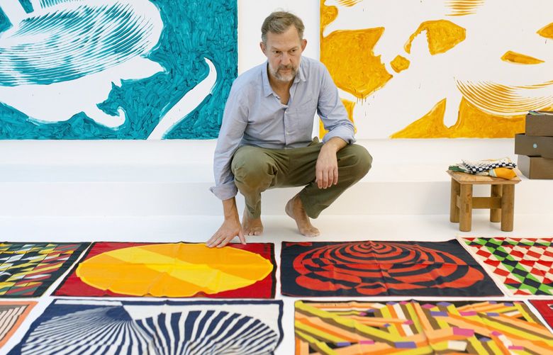 Benoit Pierre Emery displays scarves from his collection in his studio in Paris on July 24, 2022. When Emery bought a silk Dior scarf from the 1970s for about $30 on eBay in 2001, little did he realize it would be the seed of a collection that would grow to more than 10,000 pieces over two decades and lead to a book to be published later this year. (Elliott Verdier/The New York Times) XNYT79 XNYT79
