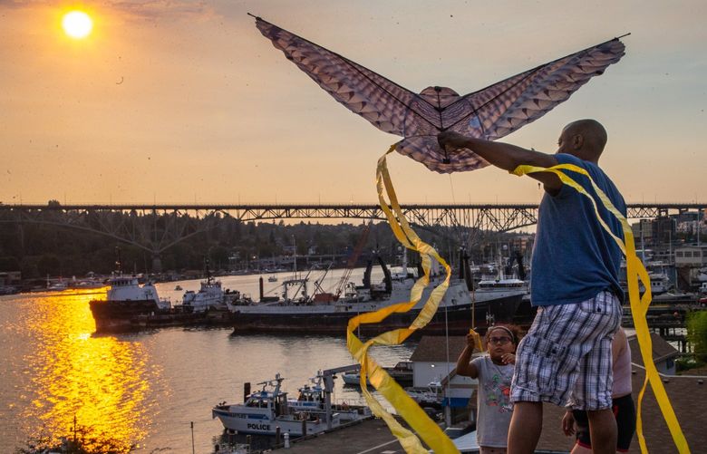 Melis Humphrey flies a kite with the help of her father, Pierre Humphrey, at Gas Works Park on Friday, Sept. 2, 2022. The family recently got the kite and had also gone to Gas Works Park on Sunday to try it out for the first time.
