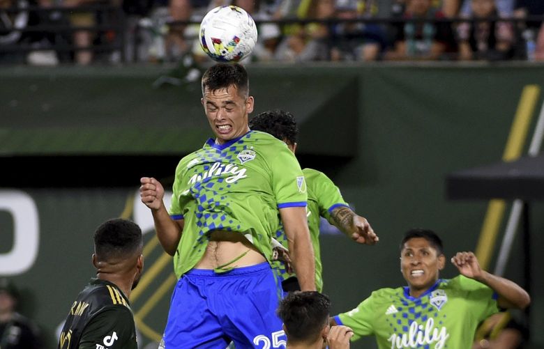 Seattle Sounders defender Jackson Ragen, goes up for a ball in front of a host of Portland Timbers during the second half of an MLS soccer match in Portland, Ore., Friday, Aug. 26, 2022. The Timbers won 2-1. (AP Photo/Steve Dykes) ORSD109 ORSD109
