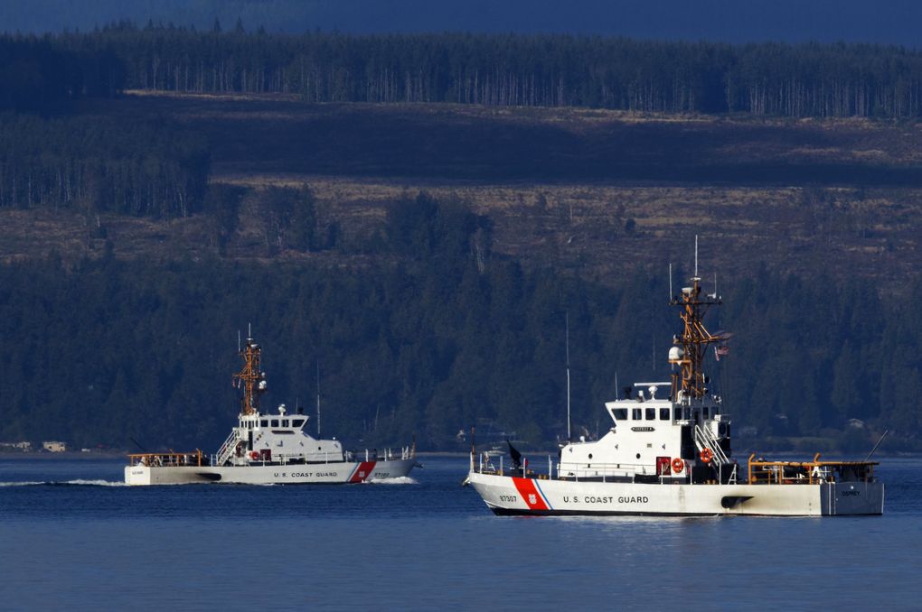 U.S. Coast Guard vessels search the waters of Mutiny Bay, west of Whidbey Island