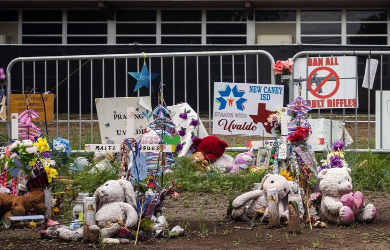 FILE – Flowers, stuffed animals and signs comprise an informal memorial outside Robb Elementary School in Uvalde, Texas, on Aug. 24, 2022. The building is closed and set to be demolished. (Tamir Kalifa/The New York Times) XNYT49 XNYT49