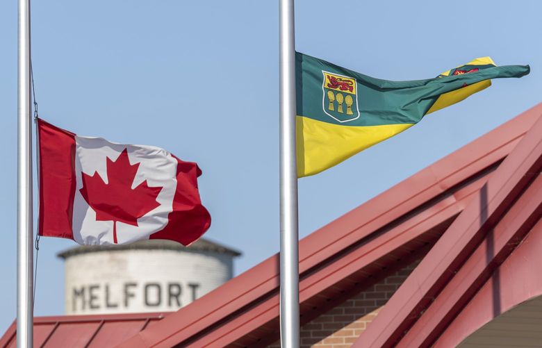 The flag of Canada and the flag of Saskatchewan are at half-mast to show respect to the victims of the stabbing rampage that happened at James Smith Cree Nation and Welton at the City Hall of Melfort, in Saskatchewan, on Wednesday, Sept. 7, 2022. (Heywood Yu/The Canadian Press via AP) HCY101 HCY101