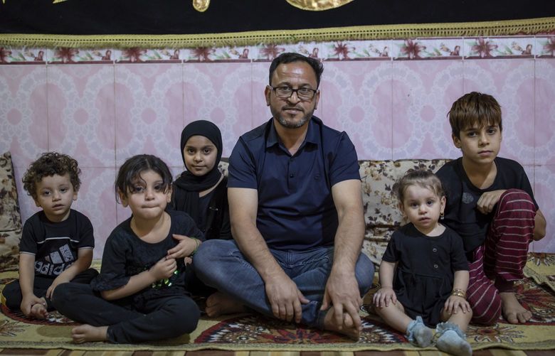 Qusay Ali, one of the fired workers protesting at the Basra Oil Co., sits with four of his children and a nephew in his home in Basra on Aug. 19. MUST CREDIT: Photo for The Washington Post by Younes Mohammad