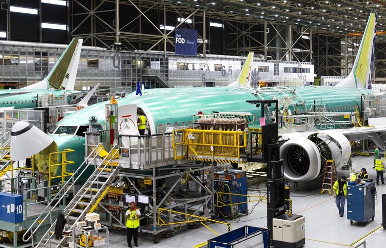 Boeing employees work on the 737 MAX on the final assembly line at Boeingís Renton plant Wednesday, June 15, 2022. 220682
