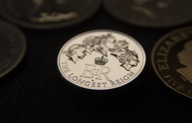 FILE – A view of commemorative coin showing portraits of Britain’s Queen Elizabeth II from the start of her reign, at left, to the present is displayed at The Royal Mint, Llantrisant, Wales, Tuesday, Aug. 18, 2015.  Elizabeth was the oldest and longest-reigning monarch in British history. In September 2015 she surpassed her great-great-grandmother Queen Victoria, who was on the throne for 63 years and 7 months. (AP Photo/Ashley Chan, File) KNOW102 KNOW102