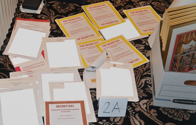 This image contained in a court filing by the Department of Justice on Aug. 30, 2022, and redacted by in part by the FBI, shows a photo of documents seized during the Aug. 8 search by the FBI of former President Donald Trump’s Mar-a-Lago estate in Florida. The Justice Department says it has uncovered efforts to obstruct its investigation into the discovery of classified records at former President Donald Trump’s Florida estate. (Department of Justice via AP) DCJE342