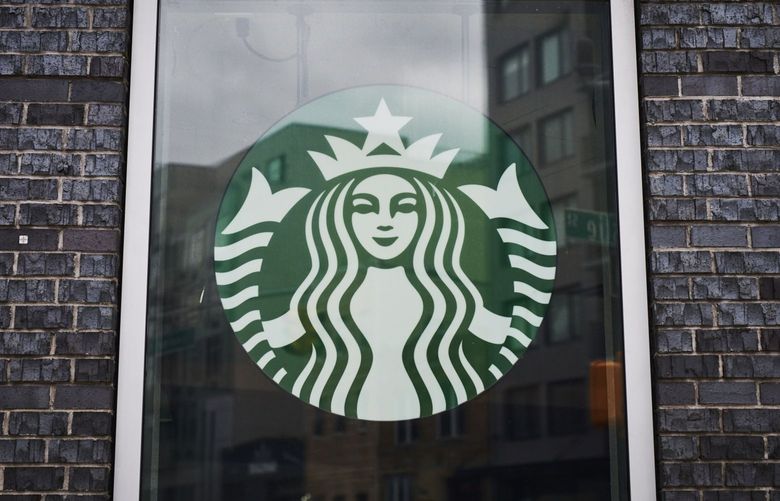 Signage is displayed at a temporarily closed Starbucks coffee shop in the Brooklyn borough of New York on April 27, 2020. Bloomberg photo by Gabby Jones.