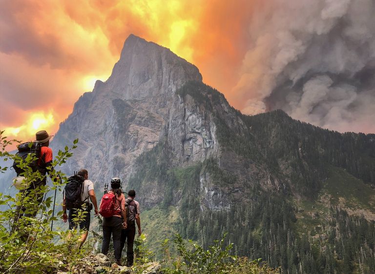 Merchant Peak climbers watch the Bolt Creek Fire rapidly progress up and over the ridge of Baring Mountain on Saturday, September 10, 2022 | photo credit Alison Dempsey-Hall, Seattle Times