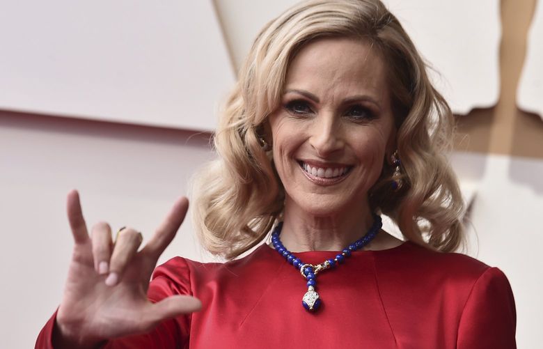 Marlee Matlin, signing ‘I love you,’ arrives at the Oscars on March 27 at the Dolby Theatre in Los Angeles. Matlin is scheduled to speak Sept. 16 at Seattle’s Moore Theatre. (Jordan Strauss / Invision / AP)