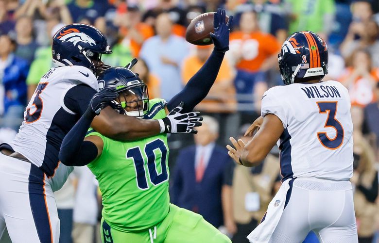 Seattle Seahawks linebacker Uchenna Nwosu gets a tip on a pass by Denver Broncos quarterback Russell Wilson during the fourth quarter Monday, Sept. 12, 2022, in Seattle. 221558