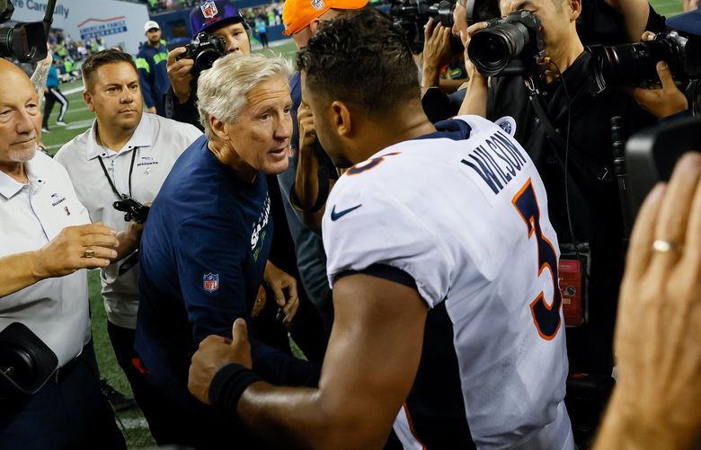 Seattle Seahawks head coach Pete Carroll shakes hands with quarterback Russell Wilson after a 17-16 win over the Denver Broncos Monday, Sept. 12, 2022, in Seattle. 221558