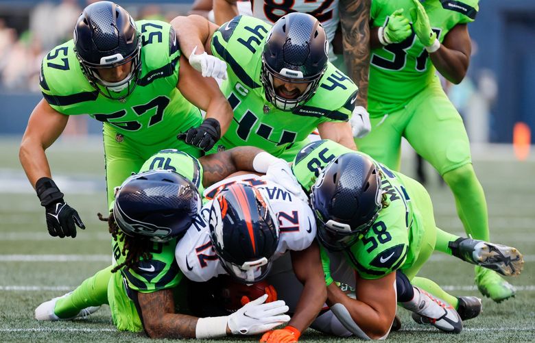 Seattle Seahawks special teamers swarm under Denver Broncos’ Montrell Washington on a kick return during the first quarter Monday, Sept. 12, 2022, in Seattle. 221558
