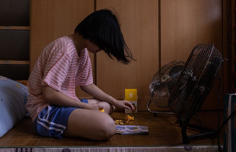 Au’s daughter plays next to fans in her room. MUST CREDIT: Photo for The Washington Post by Louise Delmotte