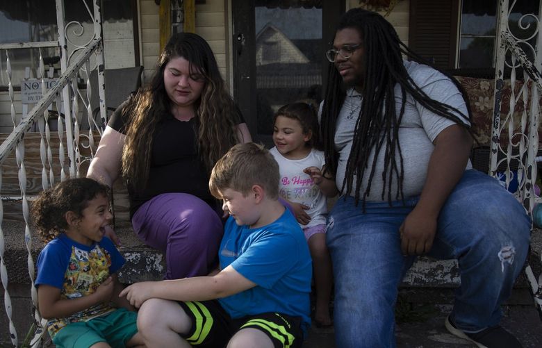 Cecelia and Jarren Jackson with their children outside their home in Huntington, W.V., May 25, 2022. For families in West Virginia, which has had especially sharp drops in child poverty over the past three decades, the shift has played out in ways not fully captured by statistics. (Maddie McGarvey/The New York Times)