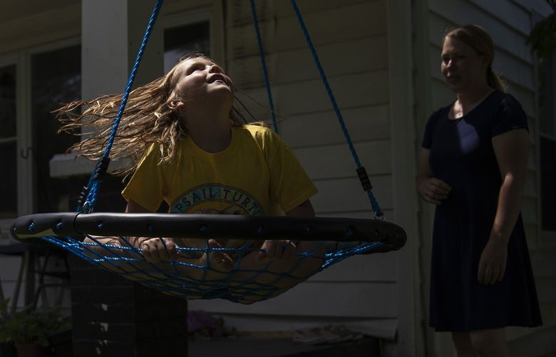 Stacy Tallman plays with her daughter Emma outside their home in Marlinton, W.V. on July 24, 2022. With little public notice and accelerating speed, child poverty fell by 59 percent from 1993 to 2019, according to a comprehensive new analysis that shows the critical role of increased government aid. (Maddie McGarvey/The New York Times)