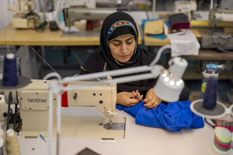 Baseerah Salim works at a sewing machine to make products at the Refugee Artisan Initiative in Lake City.  (Daniel Kim / The Seattle Times)