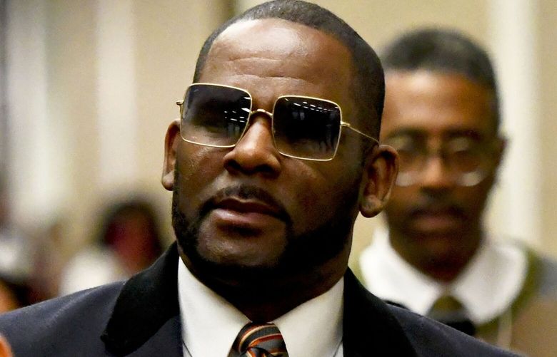 FILE – Musician R. Kelly, center, leaves the Daley Center after a hearing in his child support case on May 8, 2019, in Chicago. Closing arguments are scheduled Monday, Sept. 12, 2022 for R. Kelly and two co-defendants in the R&B singerâ€™s trial on federal charges of trial-fixing, child pornography and enticing minors for sex, with jury deliberations to follow. (AP Photo/Matt Marton, File) TKMY101 TKMY101