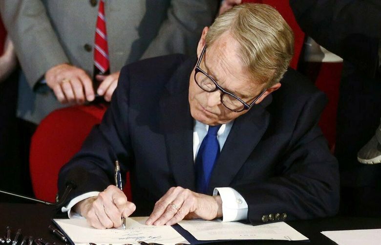 FILE – Ohio Gov. Mike DeWine signs a bill imposing one of the nation’s toughest abortion restrictions on April 11, 2019, in Columbus, Ohio. Almost three months after Roe v. Wade was overturned, the landscape of abortion access is still shifting significantly in some states. Changing restrictions and litigation in neighboring Indiana and Ohio this week illustrate the whiplash for providers and patients navigating sudden changes in what is allowed where. (Fred Squillante/The Columbus Dispatch via AP, File) OHCOL301 OHCOL301