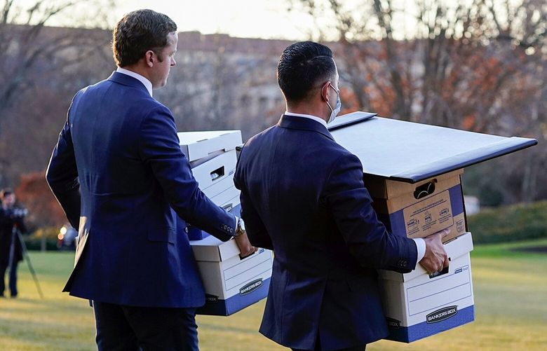 Aids carry boxes to Marine One before President Donald Trump leaves the White House, Wednesday, Jan. 20, 2021, in Washington. Trump is en route to his Mar-a-Lago Florida Resort. (AP Photo/Alex Brandon) DCAB301 DCAB301