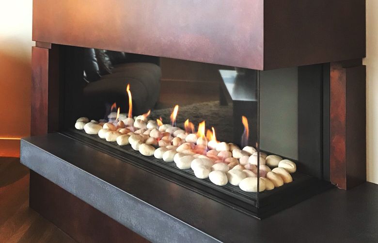 Ortal RS Corner built in gas fireplace with contemporary large white pebble media and custom steel facade.