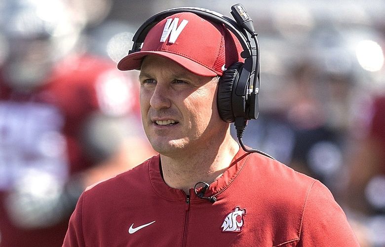 FILE – Washington State coach Jake Dickert walks across the field during the NCAA college football team’s spring game Saturday, April 23, 2022, in Pullman, Wash. Dickert took over Washington State a year ago at a time of turmoil and was proven to be the right choice for the Cougars at that time. His first season as the permanent head coach begins Saturday and the chance to prove despite being underqualified, the Cougars made the right choice long-term in Dickert.(August Frank/Lewiston Tribune via AP, File) IDLEW201 IDLEW201