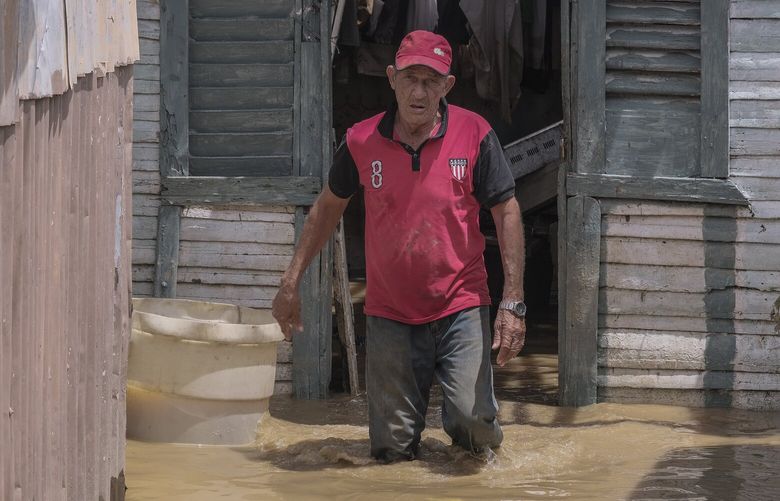 Nicasio Gil walks through the stagnant water left by the swollen Duey river after the passing of Hurricane Fiona in the Los Sotos neighborhood of HigÃ¼ey, Dominican Republic, Tuesday, Sept. 20, 2022.(AP Photo/Ricardo Hernandez) XRE117 XRE117