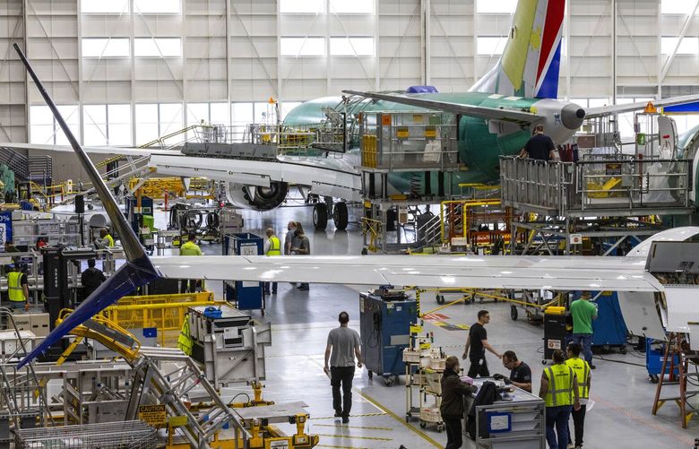 Boeing employees work on the 737 MAX on the final assembly line at Boeing‚Äôs Renton plant Wednesday, June 15, 2022. 220682